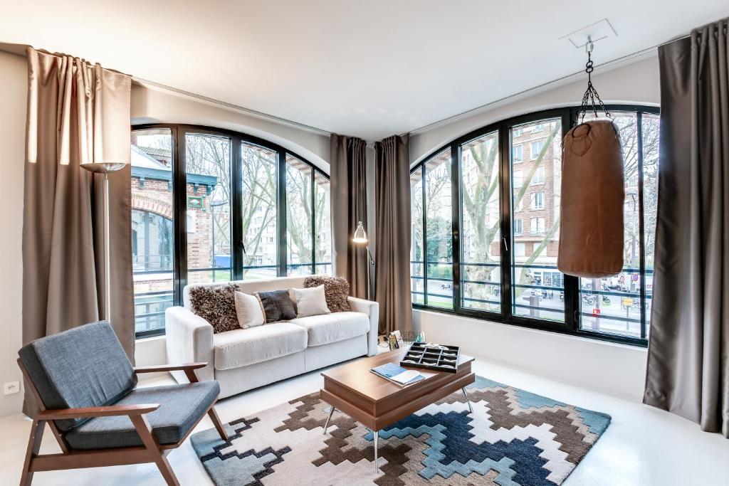 un salon avec un canapé et une table dans l'établissement Sweett - Pavillon Lumiere, à Paris