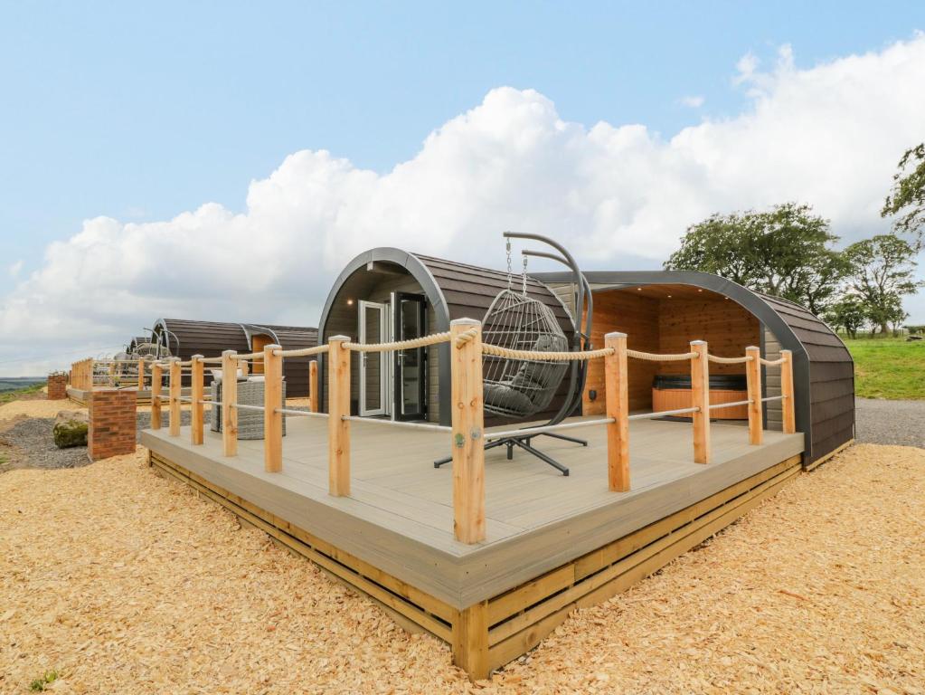 a dome house with a tennis racket on a deck at Laird Lodge 2 in Lockerbie