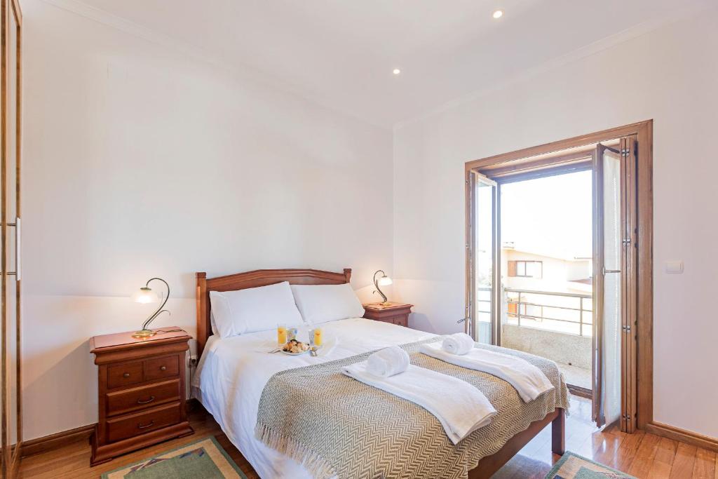 a bedroom with a bed and a large window at Mindelo Villa Beach by LovelyStay in Mindelo
