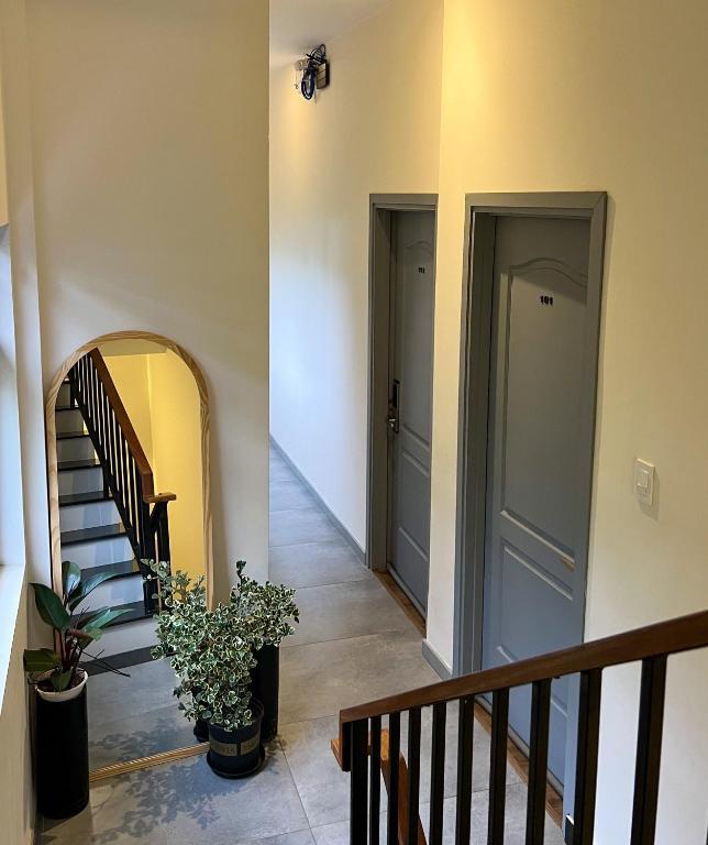 a hallway with two doors and stairs with plants at Villa Délight House “Stay&Chill” in Da Lat