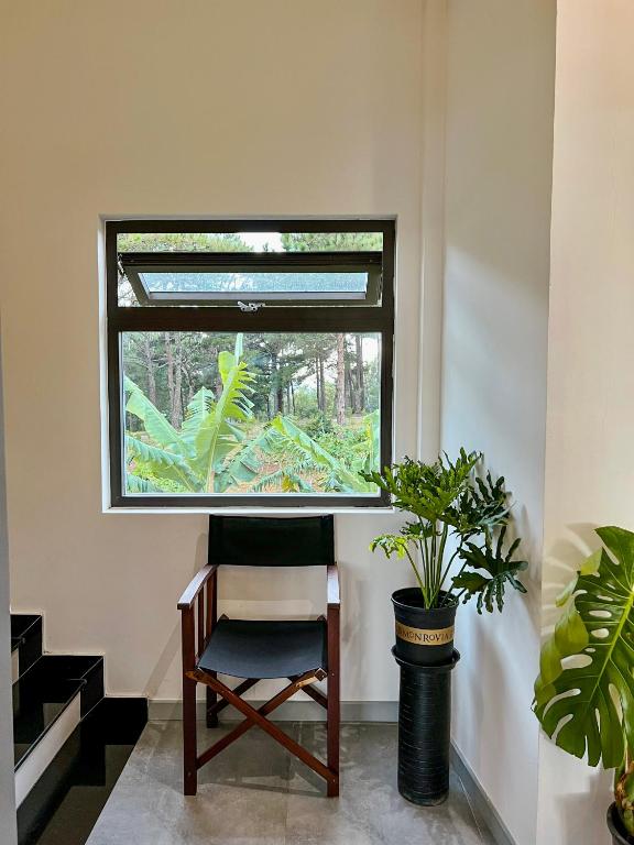 a chair in a room with a window at Villa Délight House “Stay&Chill” in Da Lat