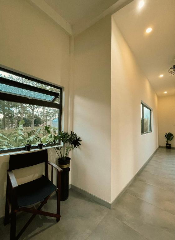a empty room with a chair and a window at Villa Délight House “Stay&Chill” in Da Lat