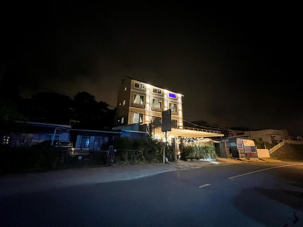 a tall building with lights on it at night at Villa Délight House “Stay&Chill” in Da Lat