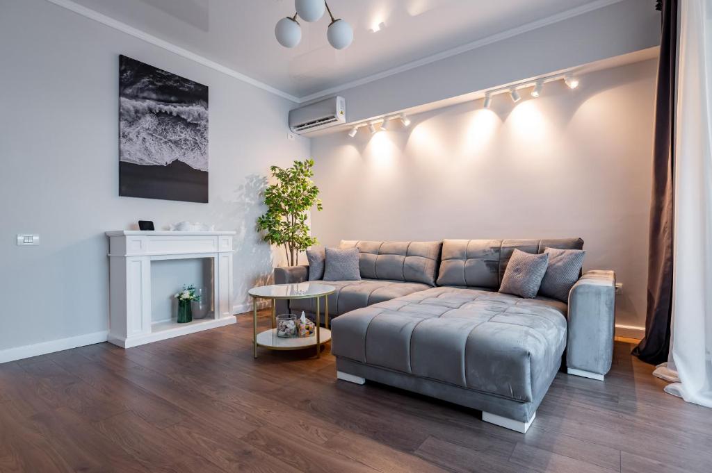 un salon avec un canapé et une cheminée dans l'établissement Golden Mirage Sunset Apartment, à Mamaia