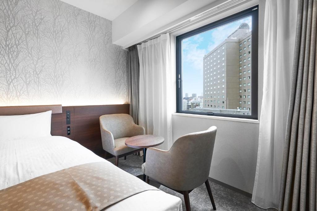 Postel nebo postele na pokoji v ubytování Daiwa Roynet Hotel Sapporo Nakajima Koen