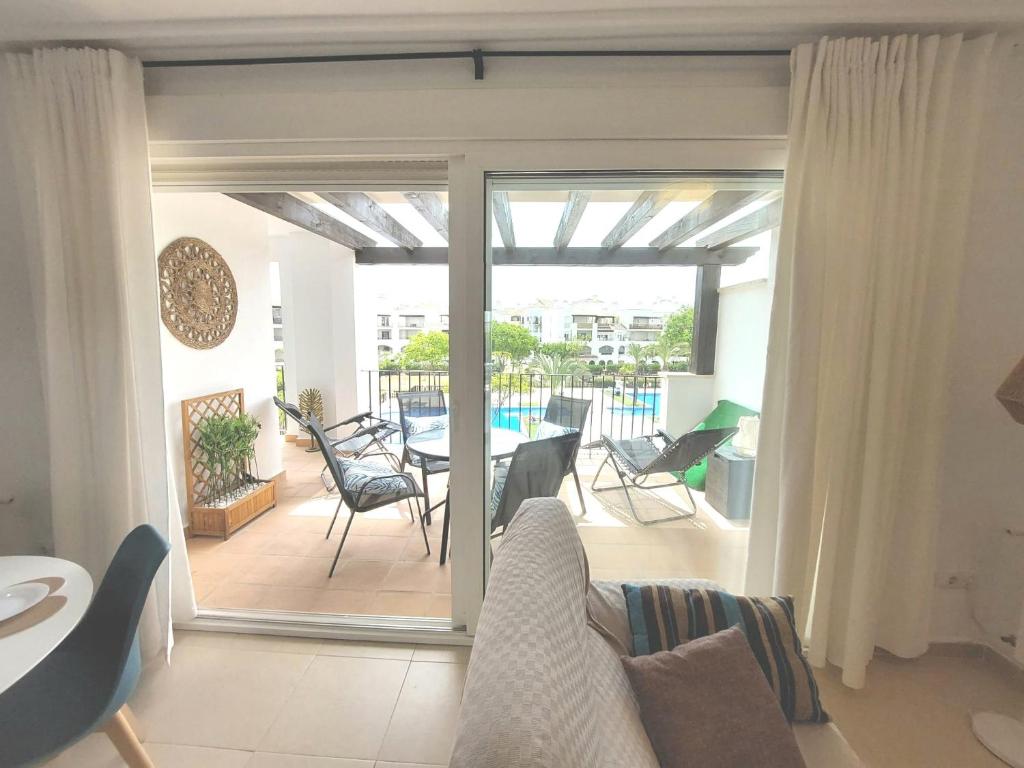 a living room with a sliding glass door leading to a patio at Modern Bright Two Bedroom Apartment With Pool Views - CO1022LT in Torre-Pacheco