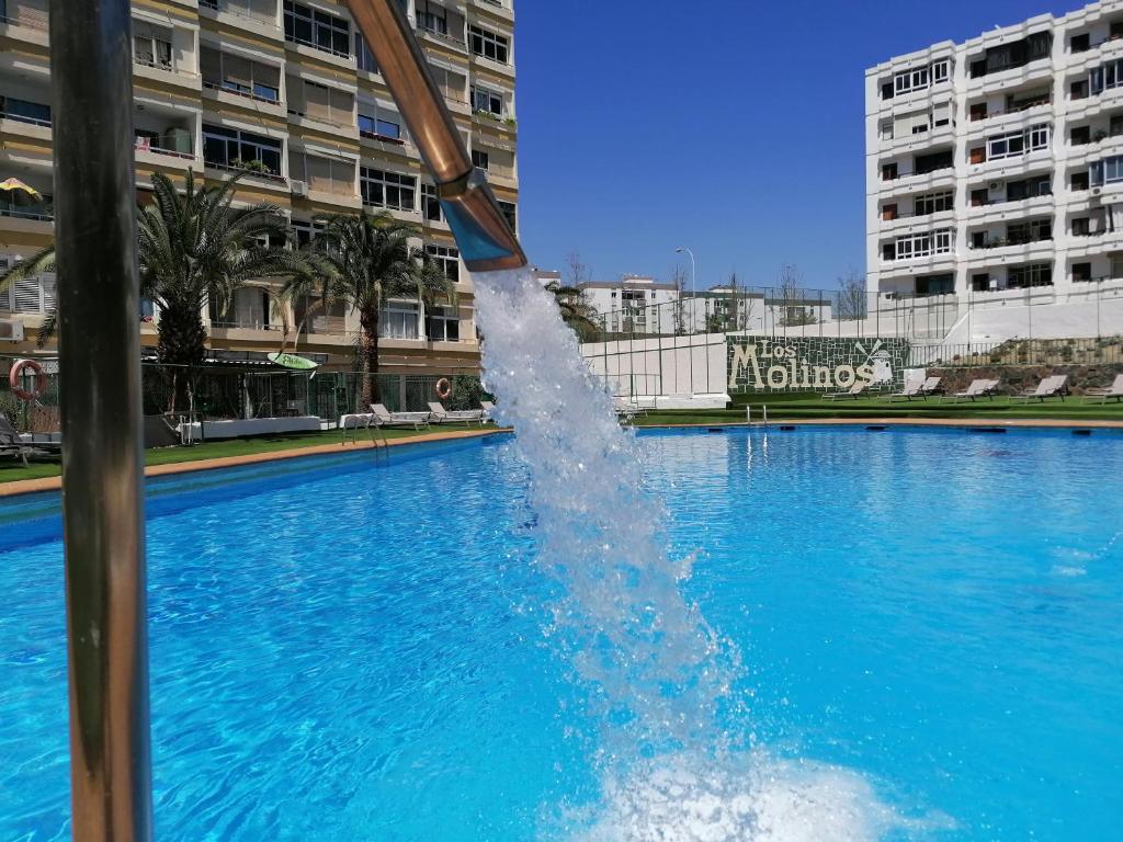 a water fountain in a pool in a city at Apartment Molinos Relax in Playa del Ingles
