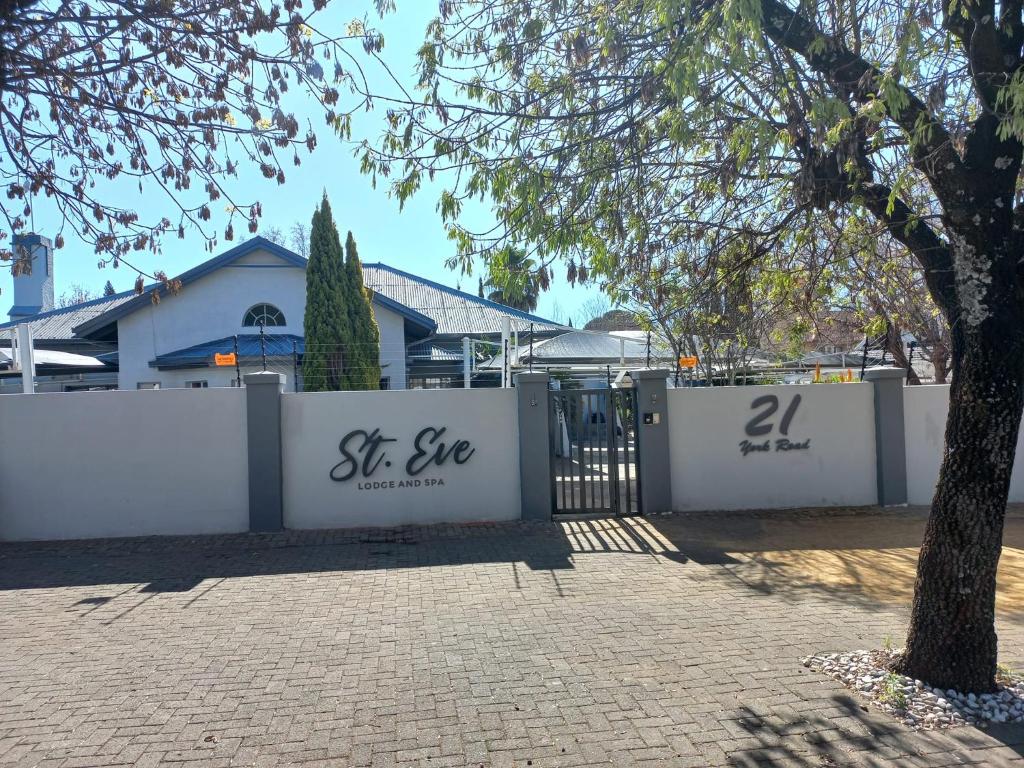 a white fence with the words st seve written on it at St Eve Lodge & Spa in Bloemfontein