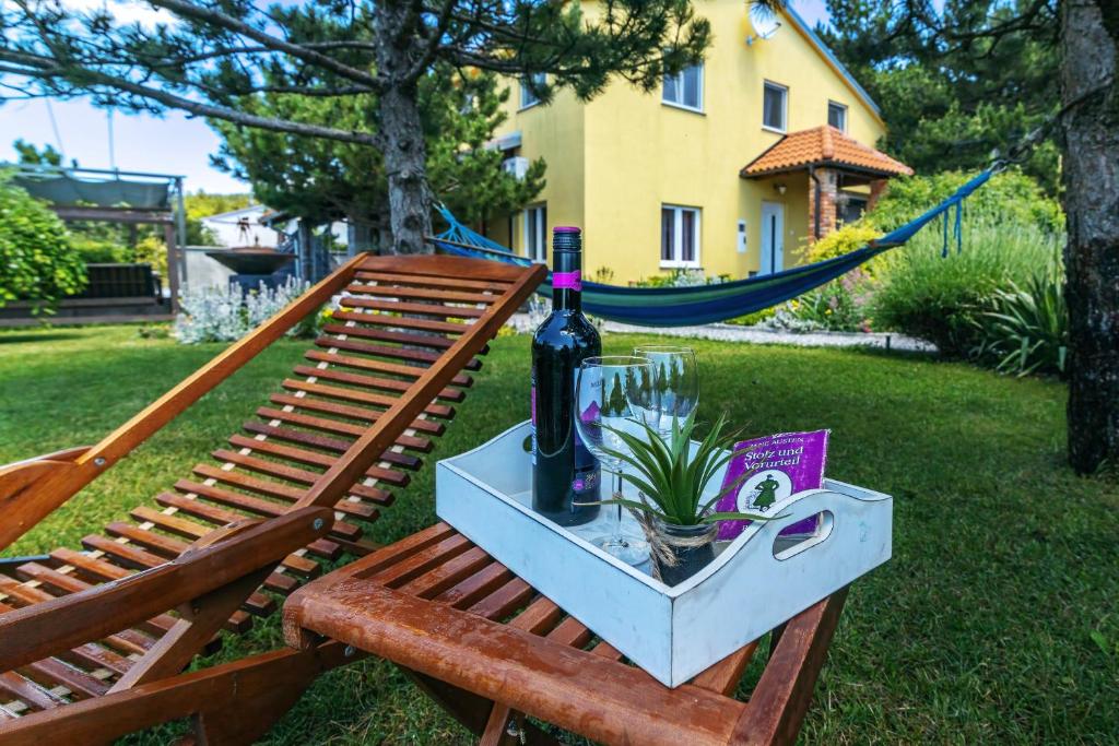 a picnic table with a bottle of wine and a plant at House Rukavina Senj in Senj