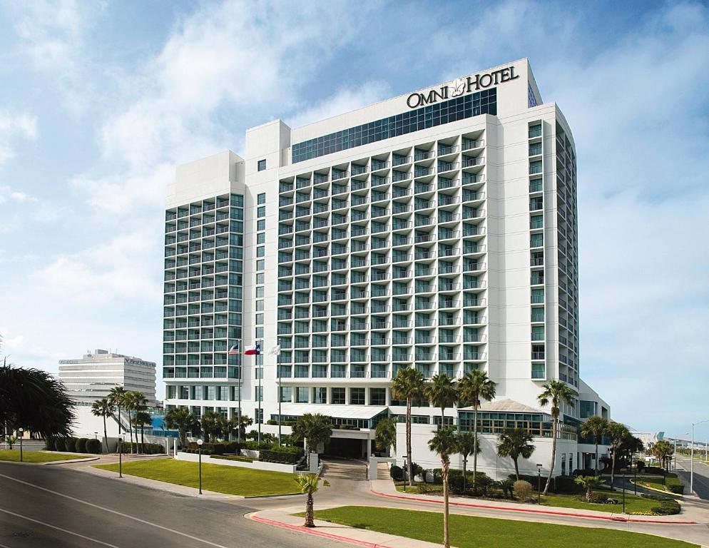 a large white building with a sign on top of it at Omni Corpus Christi Hotel in Corpus Christi