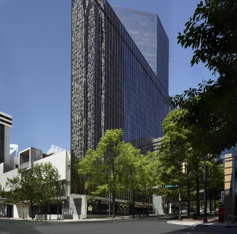 a tall building in a city with a street at Omni Charlotte Hotel in Charlotte