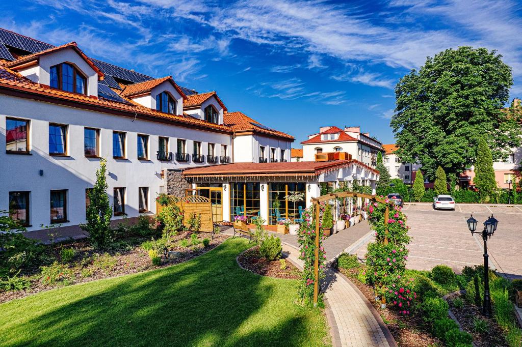 a large white building with a street in front of it at Villa Astra - Apartments & Restaurant in Oświęcim