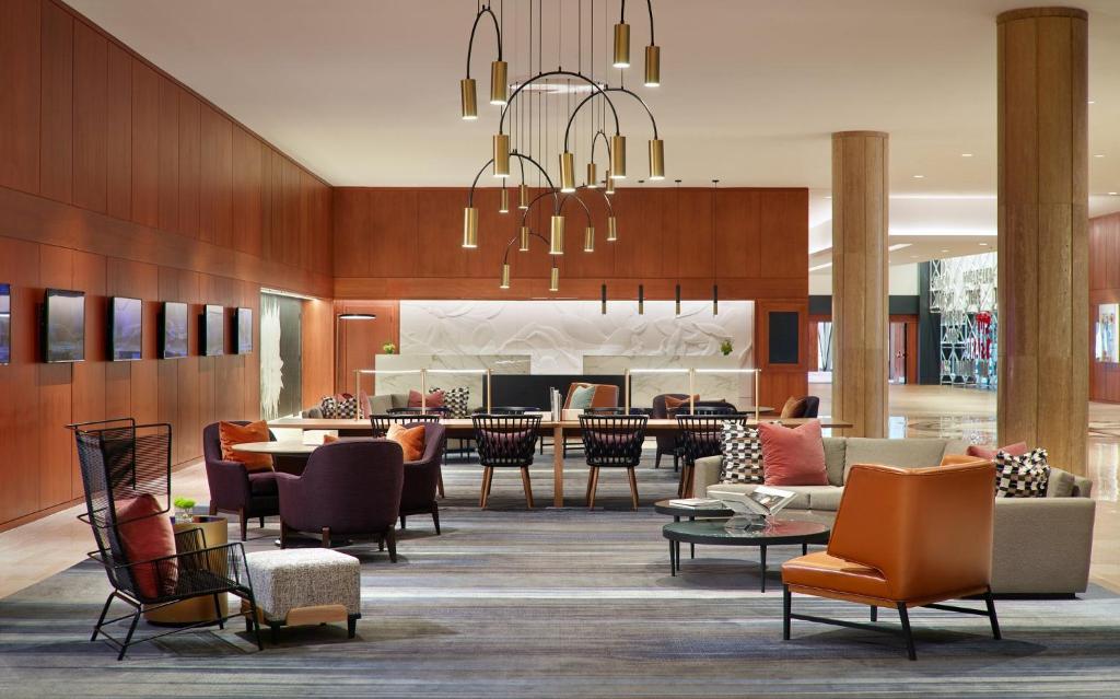 um átrio de um hotel com mesas e cadeiras em Omni Atlanta Hotel at Centennial Park em Atlanta