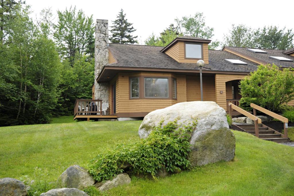 a house with a large rock in front of it at The Townhomes at Bretton Woods in Bretton Woods