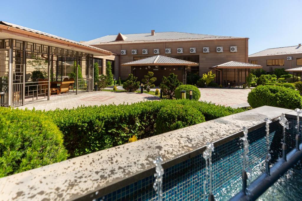 a swimming pool in front of a building at La Defense Hotel Yerevan in Yerevan
