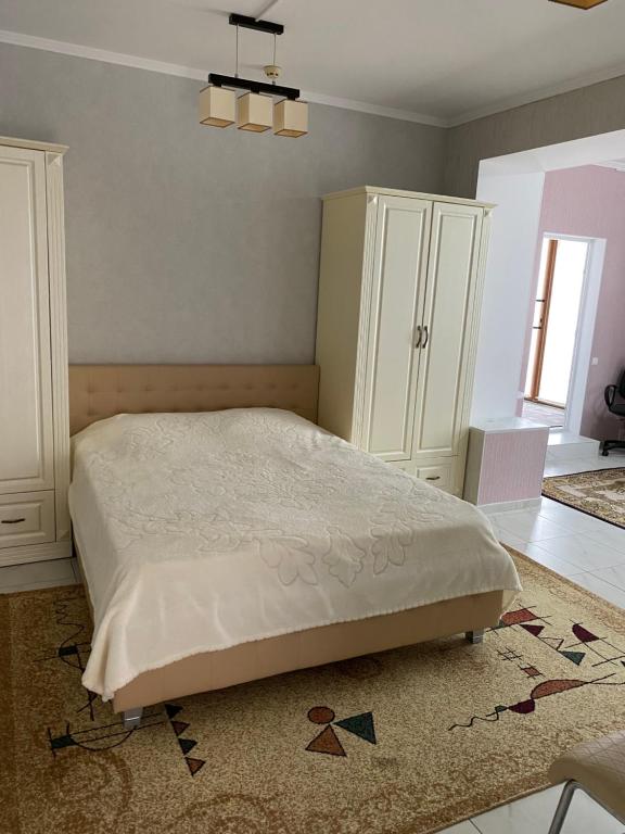 a bedroom with a bed and a cabinet and a rug at SorocaMotel in Soroca