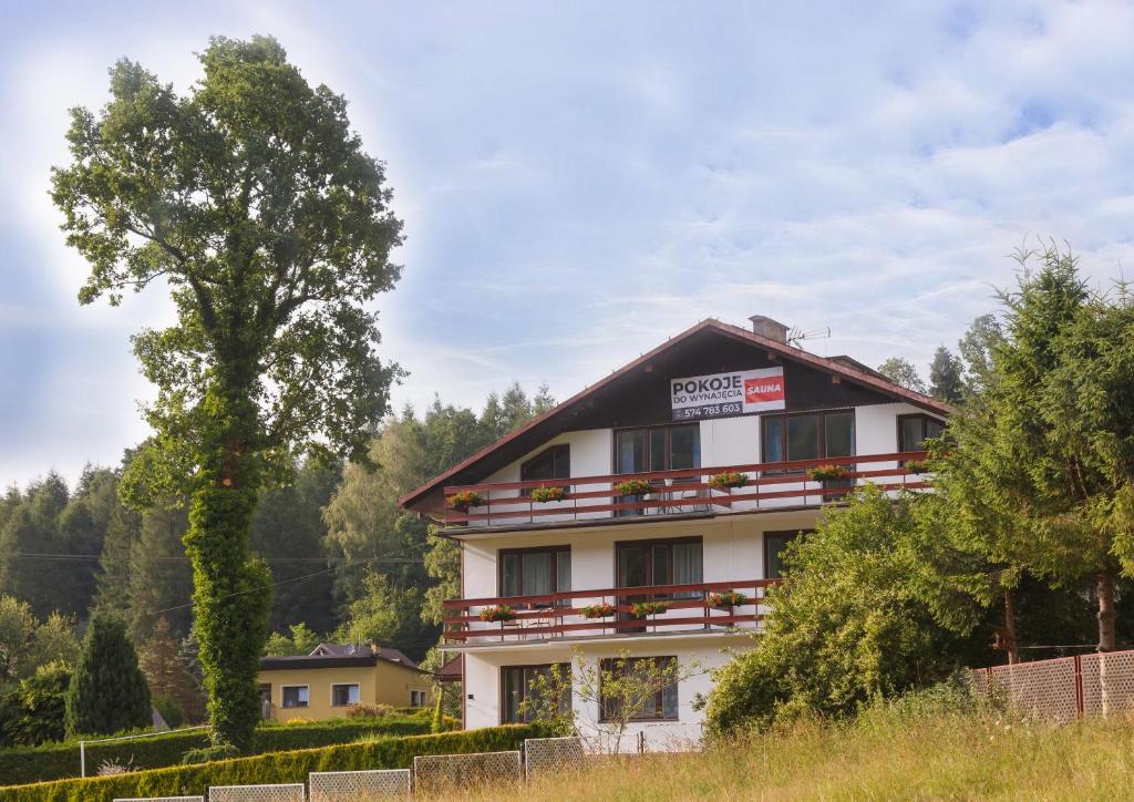 a building with a sign on top of it at U podnóża Kotarza in Brenna