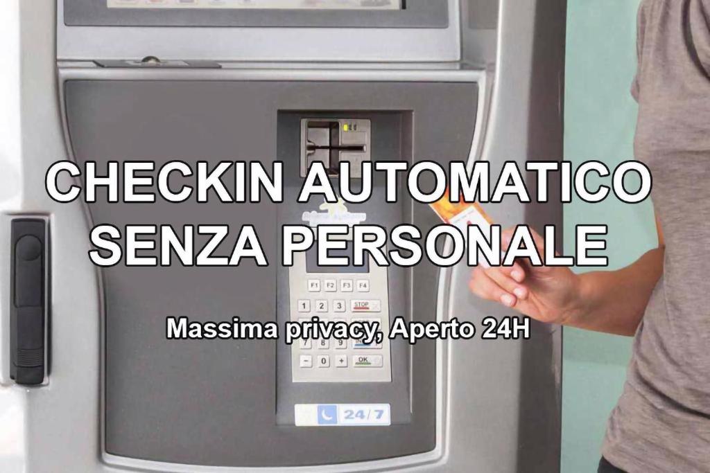 a person is standing next to an atm machine at Affittacamere Stazione Valmontone in Valmontone