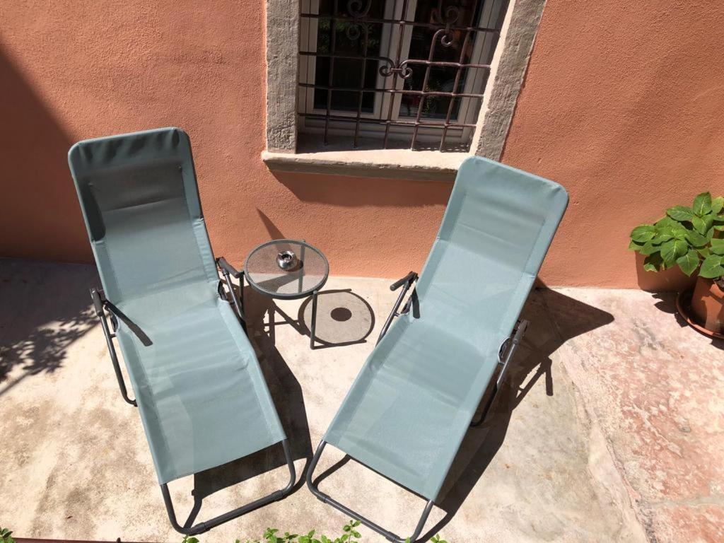 two chairs and a table in front of a building at Albergo Ristorante Montebaldo in Limone sul Garda