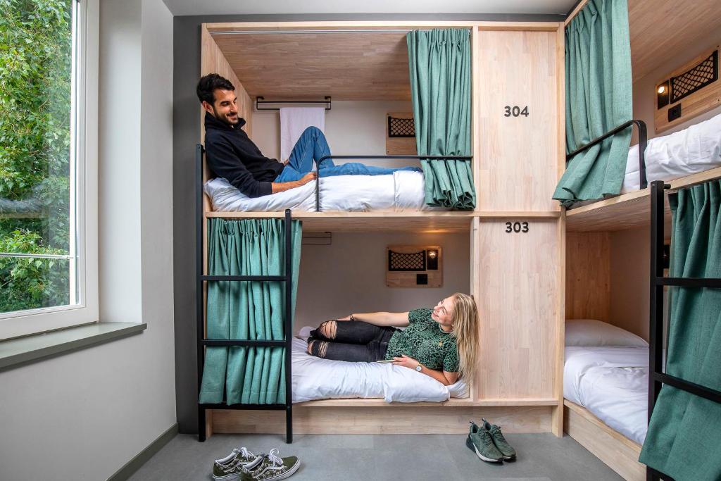 a group of people in bunk beds in a room at The Bee Hostel in Amsterdam