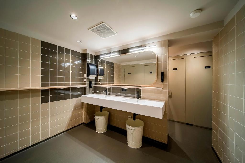 a bathroom with a sink and a mirror at The Bee Hostel in Amsterdam