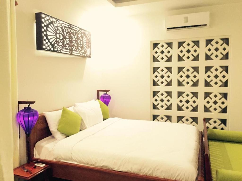 Giường trong phòng chung tại Hoi an Osaka Riverside Villa & Spa