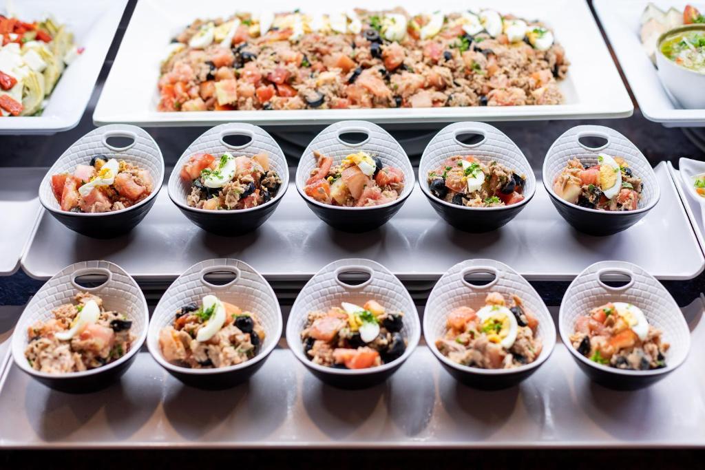 a bunch of food in plastic cups on a table at MUR Faro Jandia Fuerteventura & Spa in Morro del Jable