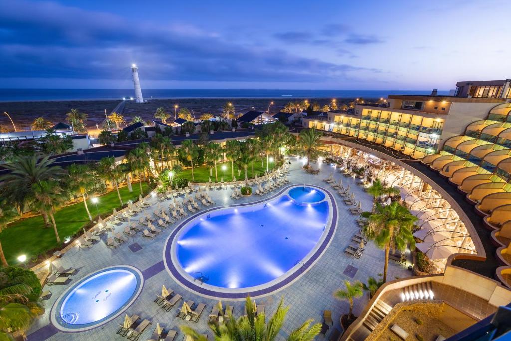 an overhead view of a resort with a pool and the ocean at MUR Faro Jandia Fuerteventura & Spa in Morro del Jable
