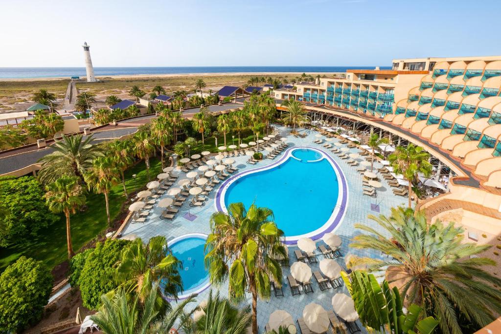 モロ・デル・ハブレにあるMUR Faro Jandia Fuerteventura & Spaのスイミングプールとビーチのあるリゾートの空からの景色を望めます。