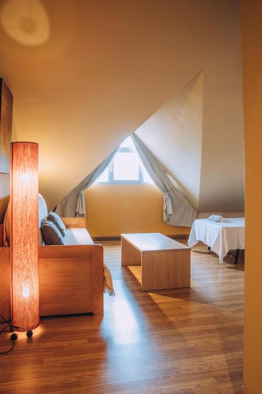 A bed or beds in a room at Hotel Arha Mar Comillas