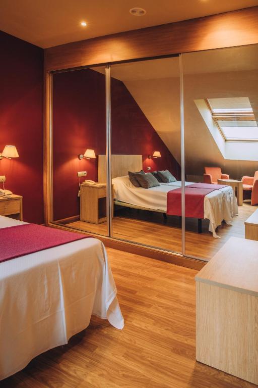 A bed or beds in a room at Hotel Arha Mar Comillas