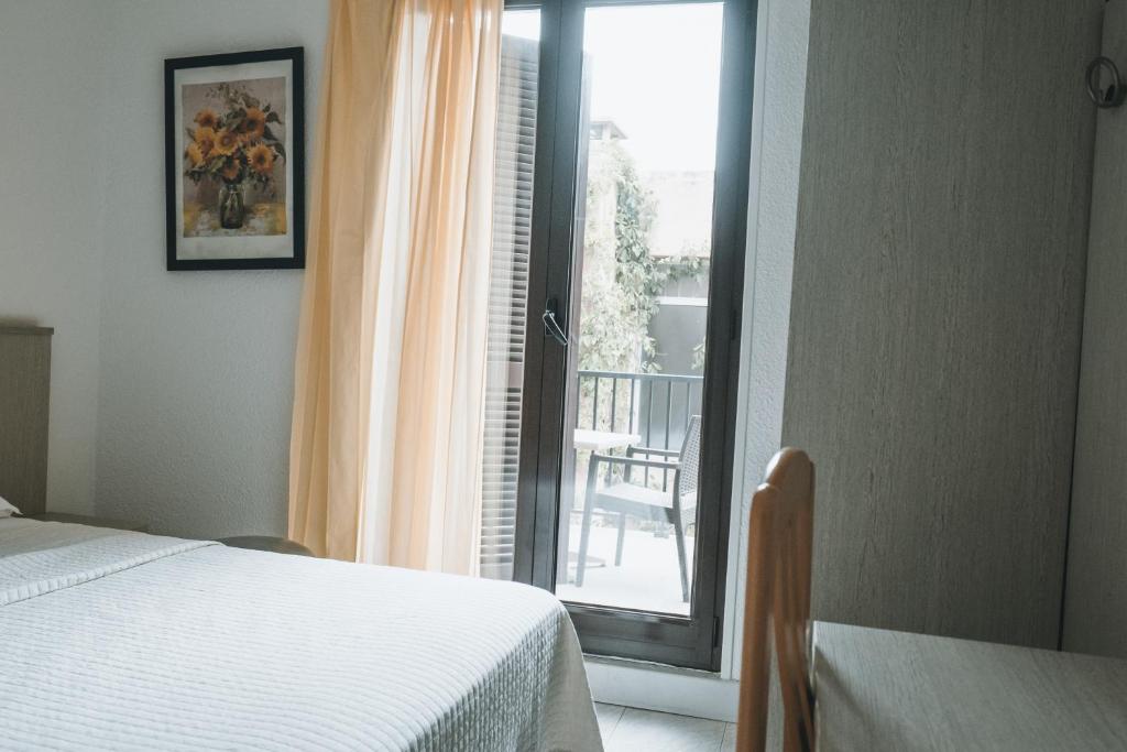 Postel nebo postele na pokoji v ubytování Hôtel Idéal