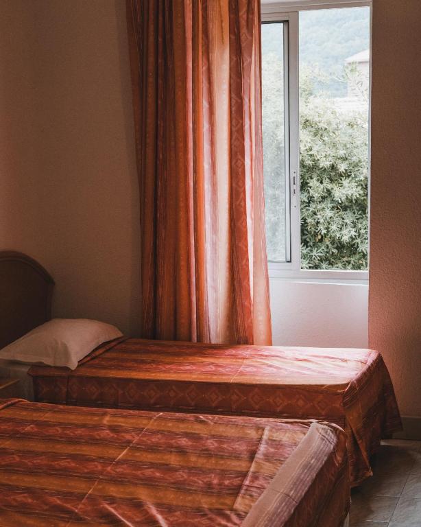 Postel nebo postele na pokoji v ubytování Hôtel Idéal