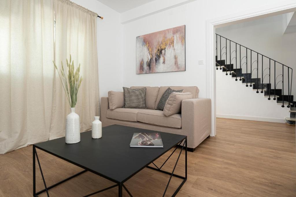 a living room with a couch and a table at Villa Santa Maria Playa Grupo AC Gestion in Cádiz