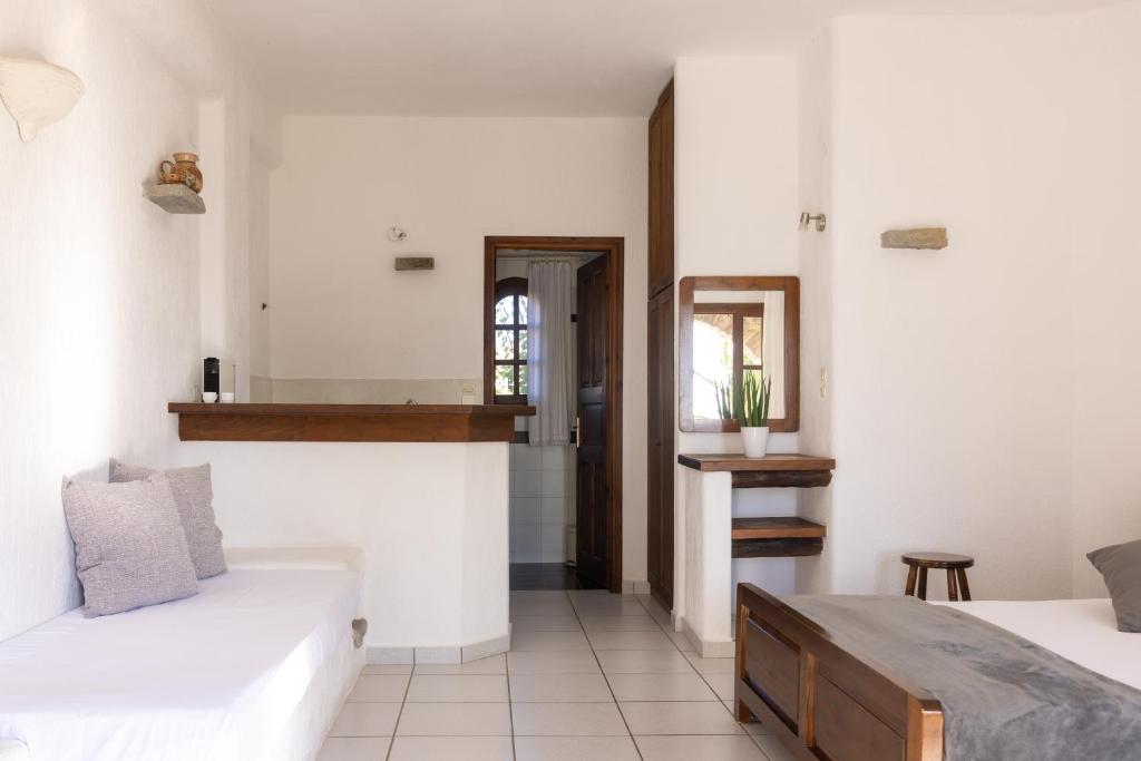 a bedroom with two beds and a mirror at Sunset Pounda in Pounda