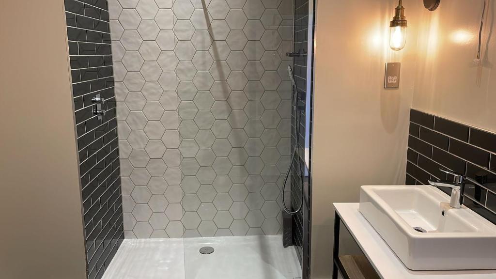 a bathroom with a shower and a sink at Downs Hotel in Stanmer