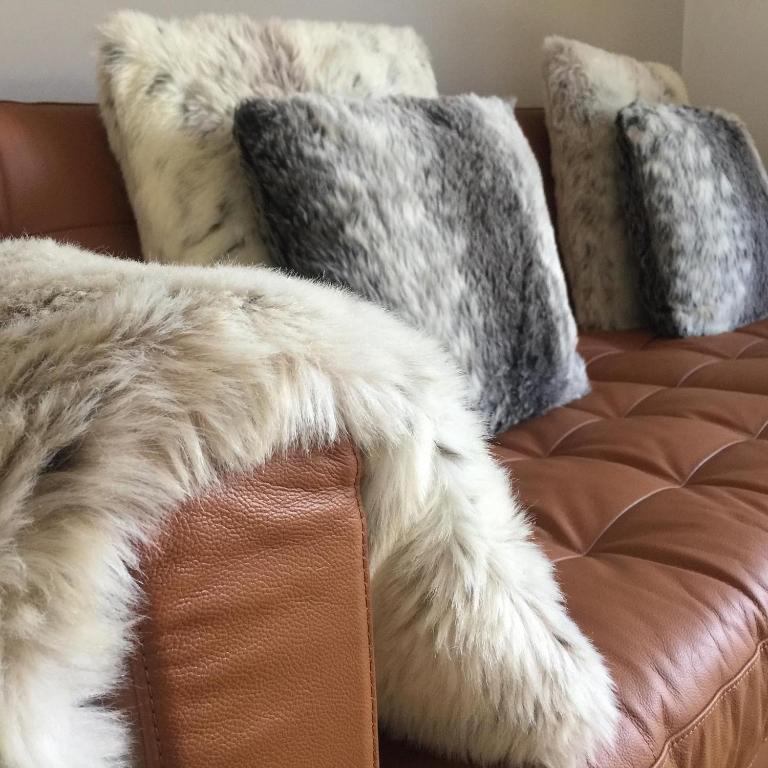 a furry couch with two pillows on top of it at Whitstable The Jolly in Whitstable