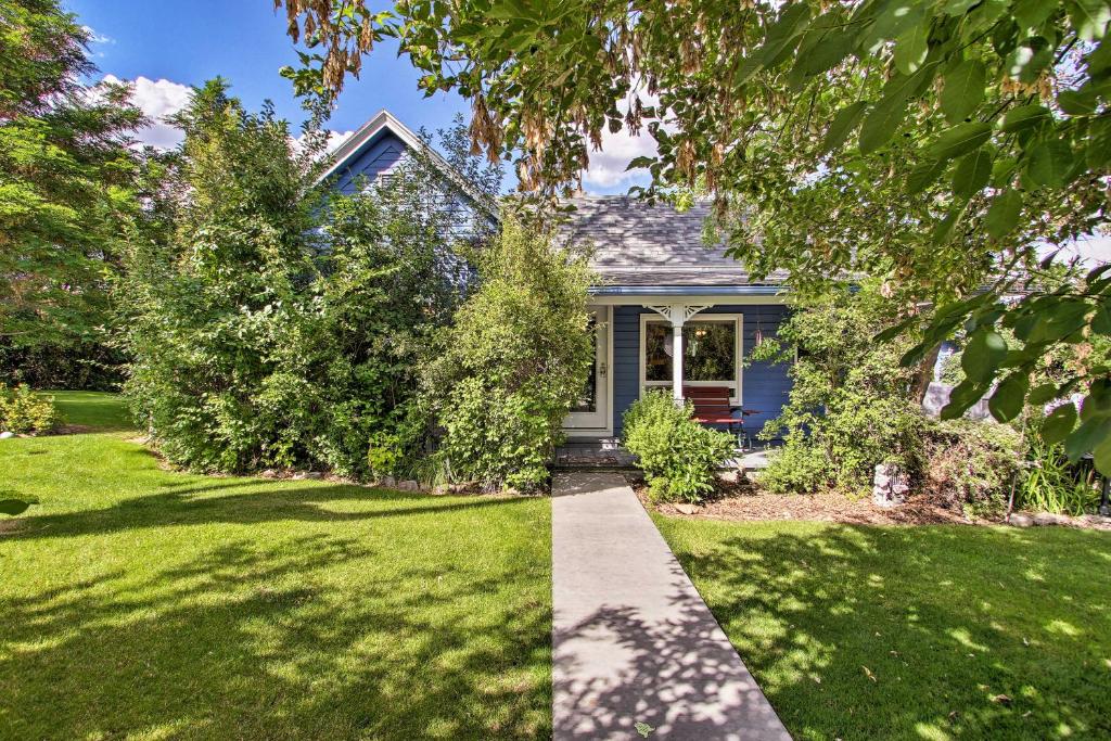 a house with a yard with green grass at Cozy Home with Hot Tub Half Mi to Salmon River! in Salmon