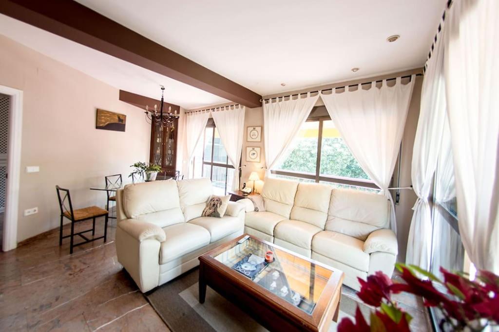 a living room with a white couch and a table at Penthouse!!! Center of Seville!!! 2 BR + 2 bath!!! in Seville