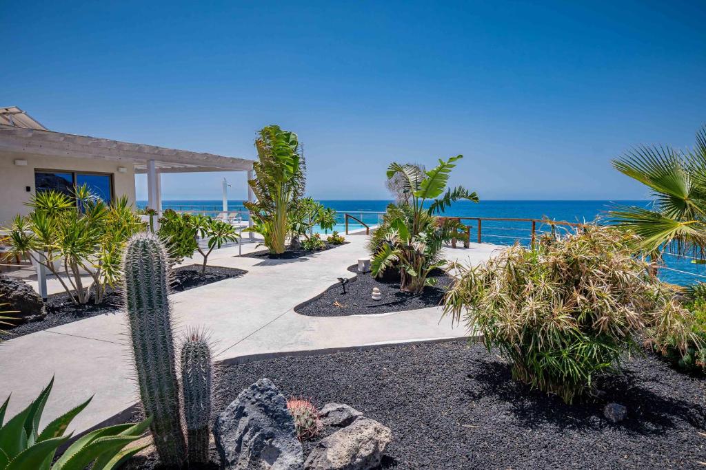 a walkway in front of a house next to the ocean at Etti - Paradise Suite El Explorador in Pájara