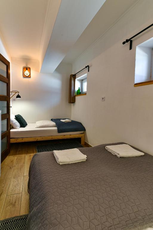 a bedroom with two beds in a room at Pitypang Apartman Felsőtárkány in Felsőtárkány