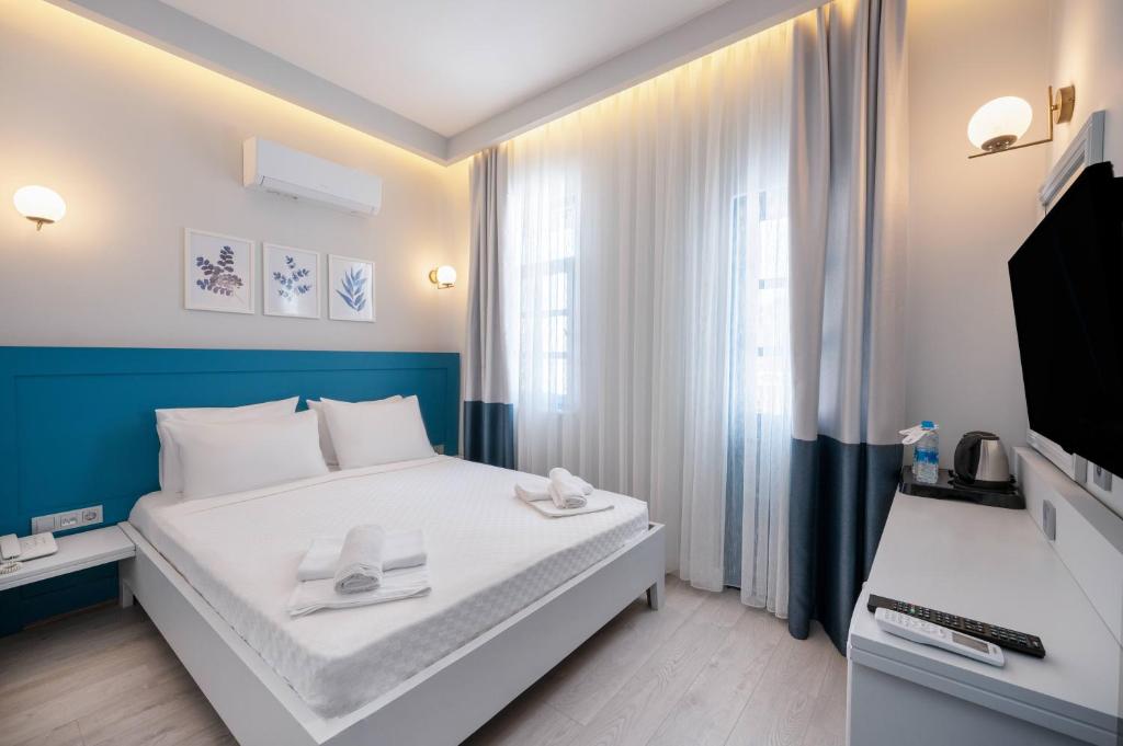 Postel nebo postele na pokoji v ubytování Kas Marin Hotel