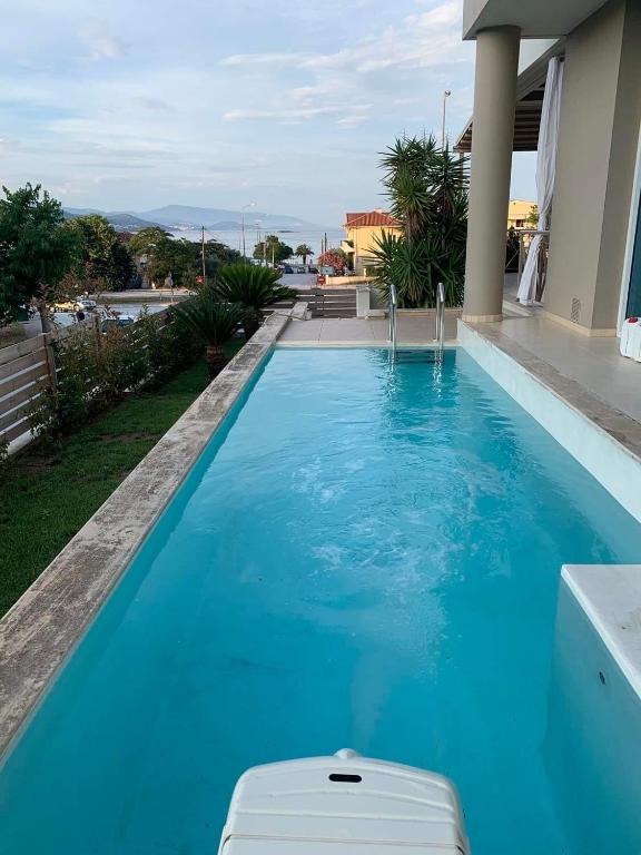 a swimming pool with blue water in a house at Villa Luminous in Iraklitsa
