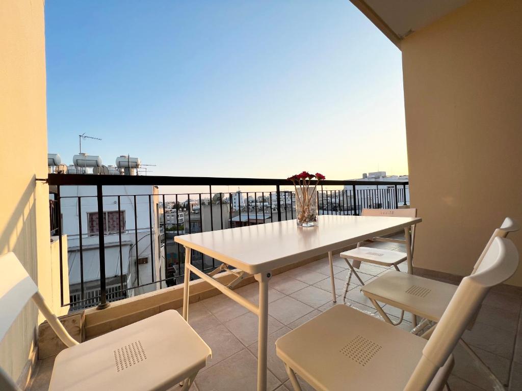 a balcony with a table and chairs and a view at Albert's apartment Centre 601 in Larnaca