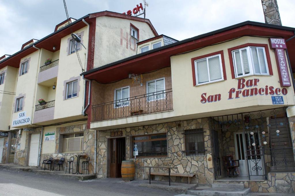 a building with a sign that reads for sun francisco at hostal san francisco in Puebla de Sanabria