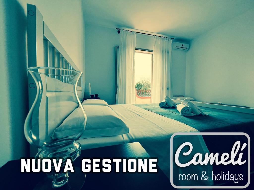 a blue bedroom with a bed and a window at Camelì Rooms & Holidays in Leporano