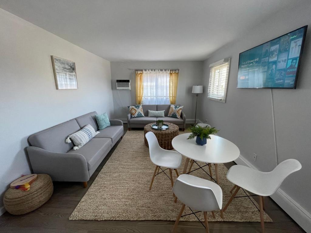 a living room with a couch and a table and chairs at Ocean Surf Resort in Montauk