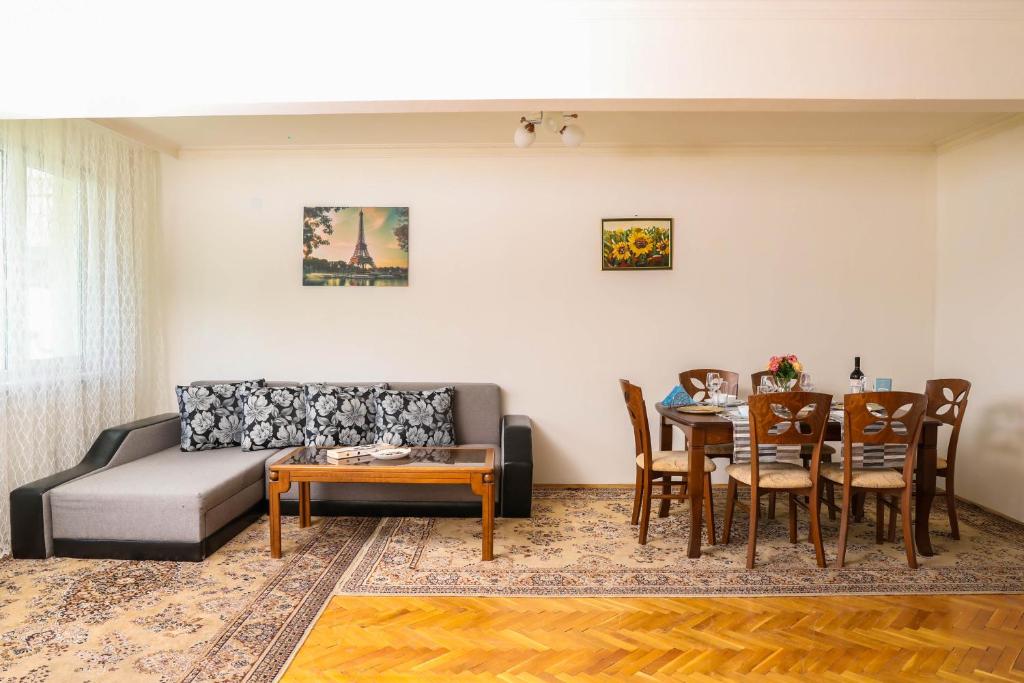 a living room with a couch and a table at Krichim Apartments,Three-Bedroom, large apartment, TOP CENTER in Sofia