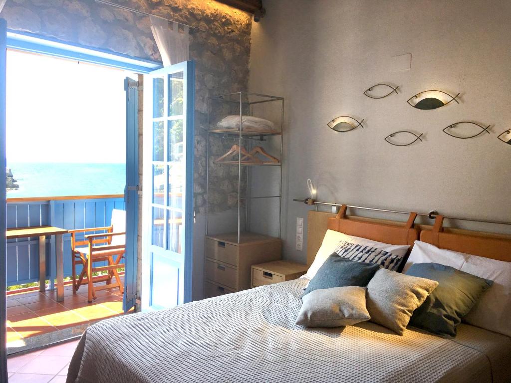 a bedroom with a bed with a view of the ocean at Arenaria Leucadia in Agios Nikitas