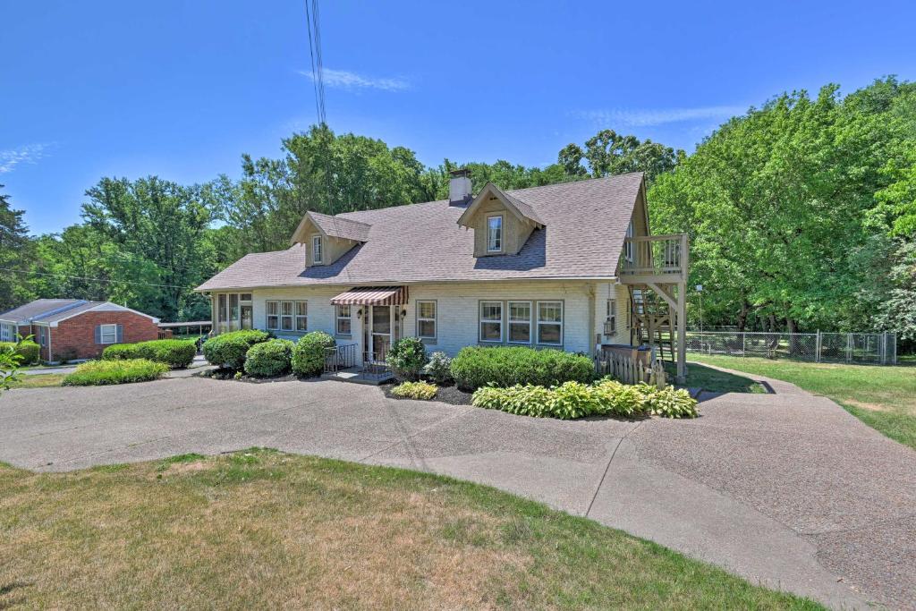 a house with a porch and a driveway at Spacious Nashville Retreat about 6 Miles to Broadway! in Nashville